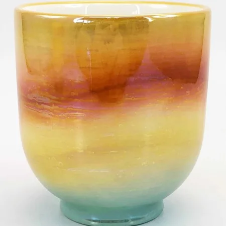 Ceramic candle vessel in a multicolor reactive glaze