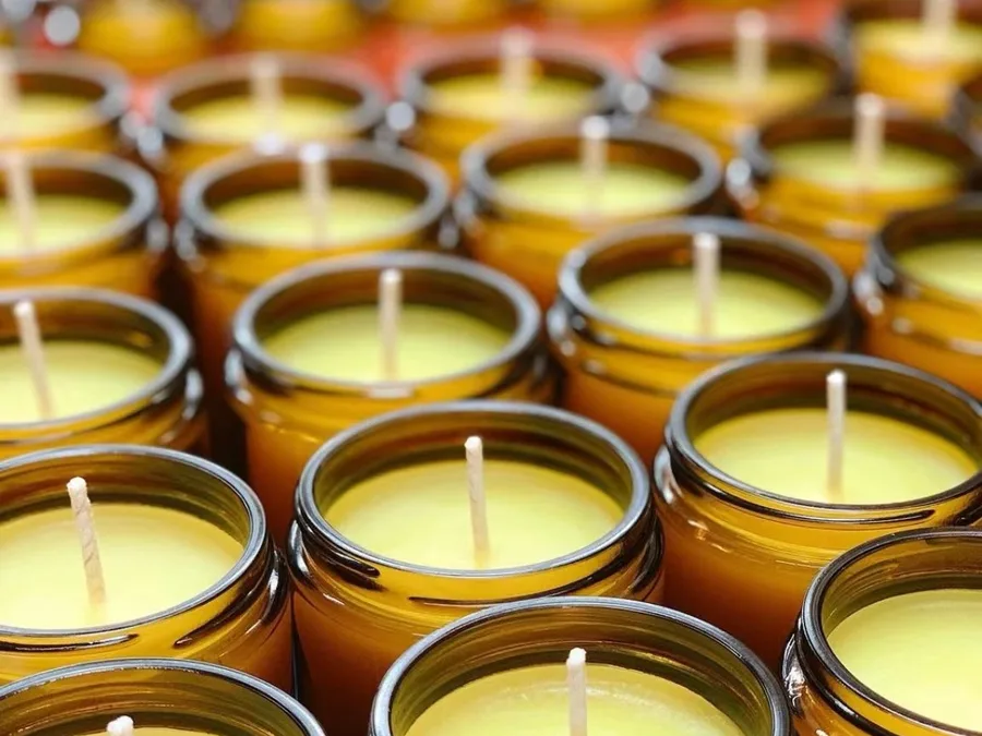 Filled amber glass candles with cotton wicks